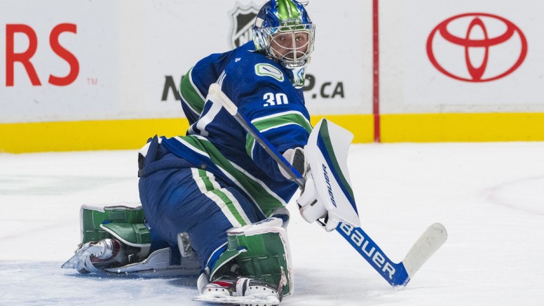 Jan 25, 2022; Vancouver, British Columbia, CAN; Vacnouver Canucks goalie Spencer Martin (30) makes a save against the Edmonton Oilers in the overtime period at Rogers Arena. Oilers won 3-2 in Overtime. Mandatory Credit: Bob Frid-USA TODAY Sports