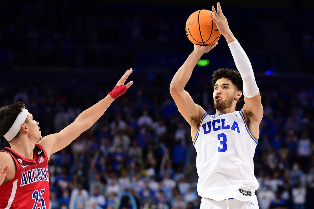 Jan 25, 2022; Los Angeles, California, USA; UCLA Bruins guard Johnny Juzang (3) shoots against Arizona Wildcats guard Kerr Kriisa (25) during the second half at Pauley Pavilion. Mandatory Credit: Gary A. Vasquez-USA TODAY Sports