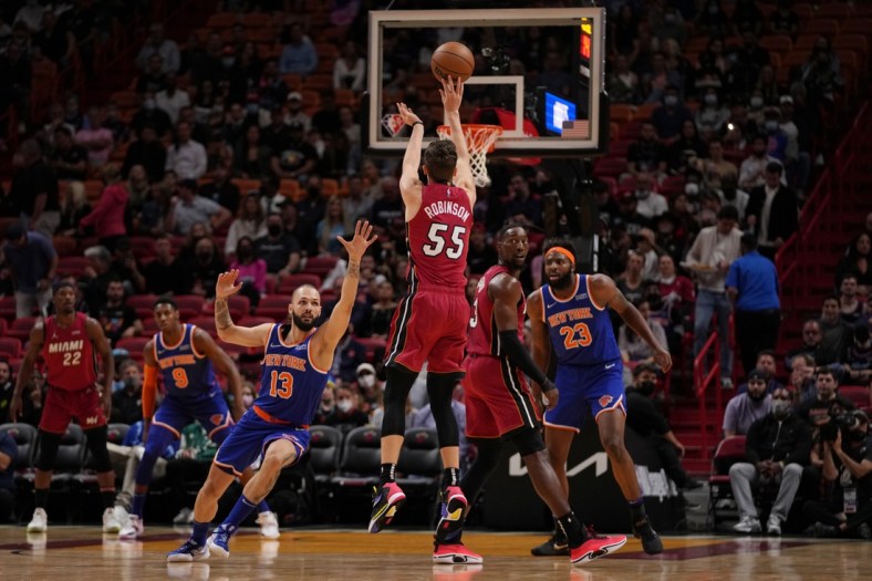 Jan 26, 2022; Miami, Florida, USA; Miami Heat guard Duncan Robinson (55) attempts a three point shot over New York Knicks guard Evan Fournier (13) during the first half at FTX Arena. Mandatory Credit: Jasen Vinlove-USA TODAY Sports