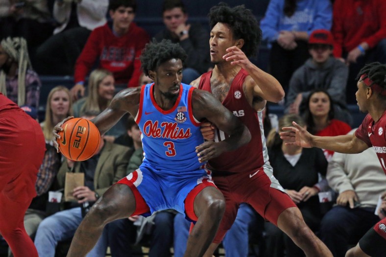 Jan 26, 2022; Oxford, Mississippi, USA; Mississippi Rebels center Nysier Brooks (3) drives to the basket as Arkansas Razorbacks forward Jaylin Williams (10) defends during the first half at The Sandy and John Black Pavilion at Ole Miss. Mandatory Credit: Petre Thomas-USA TODAY Sports