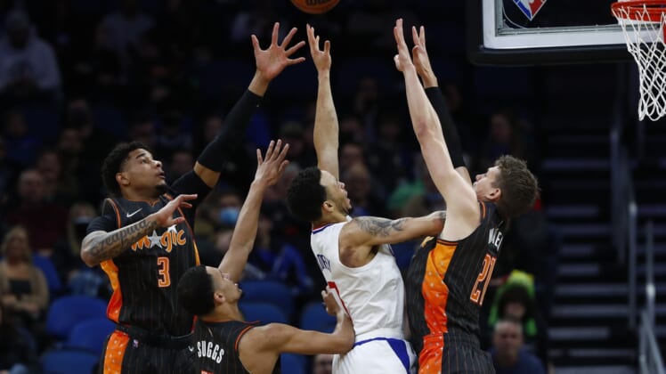 Jan 26, 2022; Orlando, Florida, USA; LA Clippers guard Amir Coffey (7) is tripled teamed by Orlando Magic forward Chuma Okeke (3), guard Jalen Suggs (4) and center Moritz Wagner (21) during the first quarter at Amway Center. Mandatory Credit: Kim Klement-USA TODAY Sports