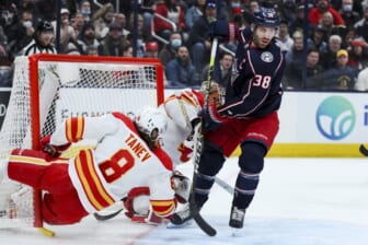 Jan 26, 2022; Columbus, Ohio, USA;  Columbus Blue Jackets center Boone Jenner (38) skates as Calgary Flames defenseman Christopher Tanev (8) collides with the net in the second period at Nationwide Arena. Mandatory Credit: Aaron Doster-USA TODAY Sports