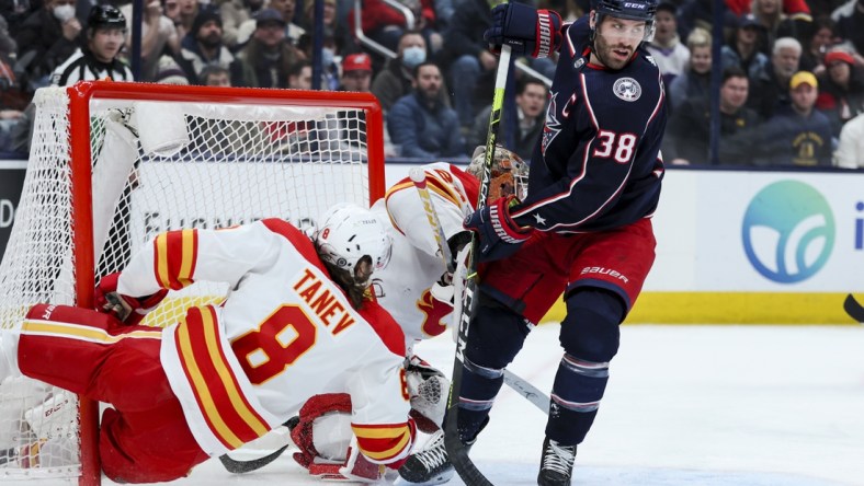 Jan 26, 2022; Columbus, Ohio, USA;  Columbus Blue Jackets center Boone Jenner (38) skates as Calgary Flames defenseman Christopher Tanev (8) collides with the net in the second period at Nationwide Arena. Mandatory Credit: Aaron Doster-USA TODAY Sports