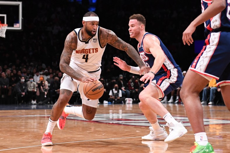 Jan 26, 2022; Brooklyn, New York, USA;  Denver Nuggets Center DeMarcus Cousins (4) drives to the basket against Brooklyn Nets forward Blake Griffin (2) during the second quarter at Barclays Center. Mandatory Credit: Dennis Schneidler-USA TODAY Sports