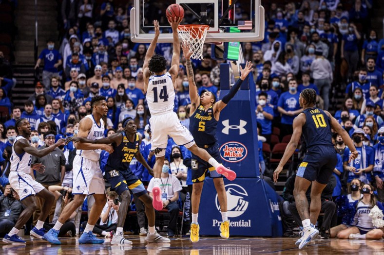 Jan 26, 2022; Newark, New Jersey, USA; Seton Hall Pirates guard Jared Rhoden (14) shoots the ball over Marquette Golden Eagles guard Greg Elliott (5) during the first half at Prudential Center. Mandatory Credit: Vincent Carchietta-USA TODAY Sports