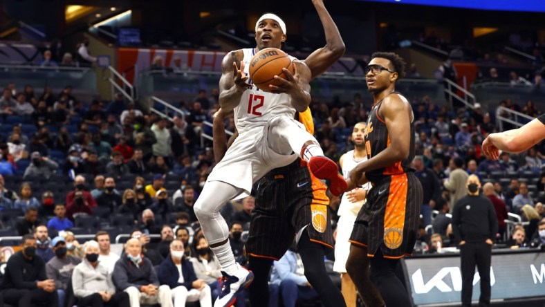 Jan 26, 2022; Orlando, Florida, USA; LA Clippers guard Eric Bledsoe (12) shoots a layup against the Orlando Magic during the second half at Amway Center. Mandatory Credit: Kim Klement-USA TODAY Sports