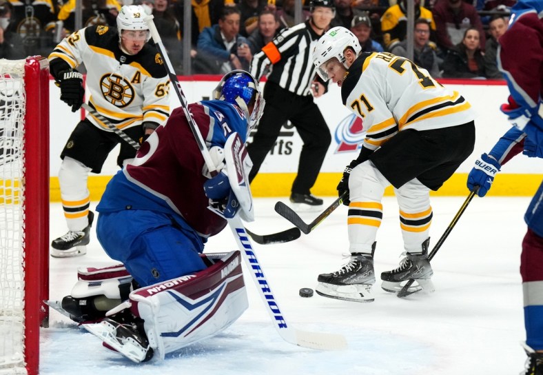 Jan 26, 2022; Denver, Colorado, USA; Boston Bruins left wing Taylor Hall (71) redirects a puck at Colorado Avalanche goaltender Darcy Kuemper (35) in the first period at Ball Arena. Mandatory Credit: Ron Chenoy-USA TODAY Sports