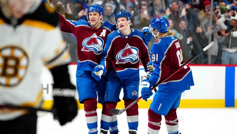 Jan 26, 2022; Denver, Colorado, USA;  Colorado Avalanche defenseman Cale Makar (8) and right wing Mikko Rantanen (96) and center Nazem Kadri (91) celebrate the overtime win against the Boston Bruins at Ball Arena. Mandatory Credit: Ron Chenoy-USA TODAY Sports