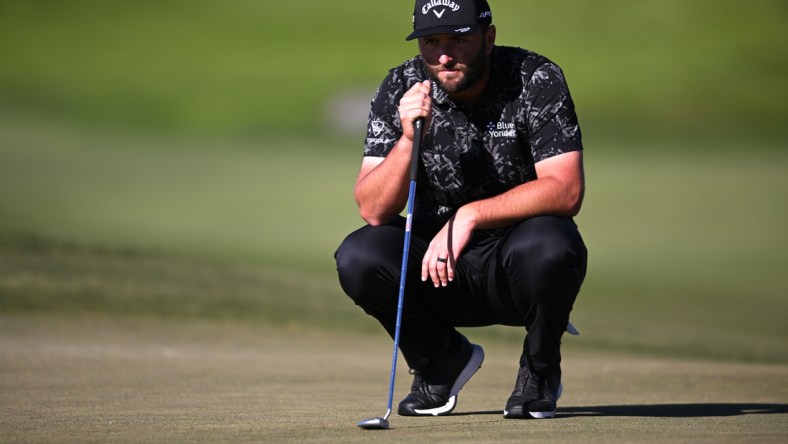 Jan 27, 2022; San Diego, California, USA; Jon Rahm lines up a putt on the ninth green during the second round of the Farmers Insurance Open golf tournament at Torrey Pines Municipal Golf Course - North Course. Mandatory Credit: Orlando Ramirez-USA TODAY Sports