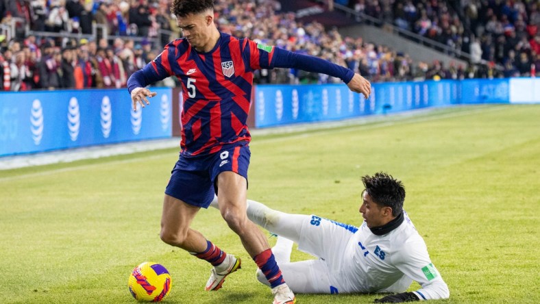 Jan 27, 2022; Columbus, Ohio, USA; United States defender Antonee Robinson (5) dribbles the ball while El Salvador defender Bryan Tamacas (21) defends during a CONCACAF FIFA World Cup Qualifier soccer match at Lower.com Field. Mandatory Credit: Trevor Ruszkowski-USA TODAY Sports