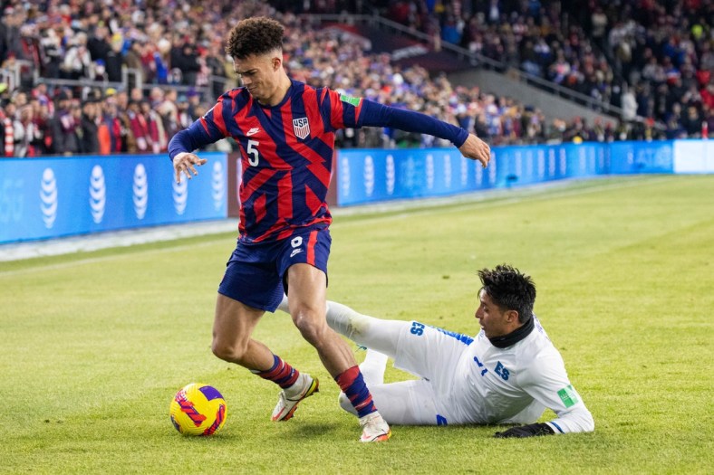 Jan 27, 2022; Columbus, Ohio, USA; United States defender Antonee Robinson (5) dribbles the ball while El Salvador defender Bryan Tamacas (21) defends during a CONCACAF FIFA World Cup Qualifier soccer match at Lower.com Field. Mandatory Credit: Trevor Ruszkowski-USA TODAY Sports