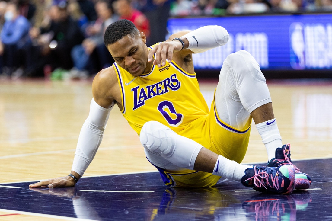 Jan 27, 2022; Philadelphia, Pennsylvania, USA; Los Angeles Lakers guard Russell Westbrook (0) sits on the court after falling during the first quarter against the Philadelphia 76ers at Wells Fargo Center. Mandatory Credit: Bill Streicher-USA TODAY Sports