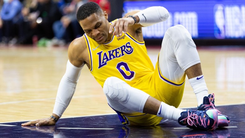 Jan 27, 2022; Philadelphia, Pennsylvania, USA; Los Angeles Lakers guard Russell Westbrook (0) sits on the court after falling during the first quarter against the Philadelphia 76ers at Wells Fargo Center. Mandatory Credit: Bill Streicher-USA TODAY Sports