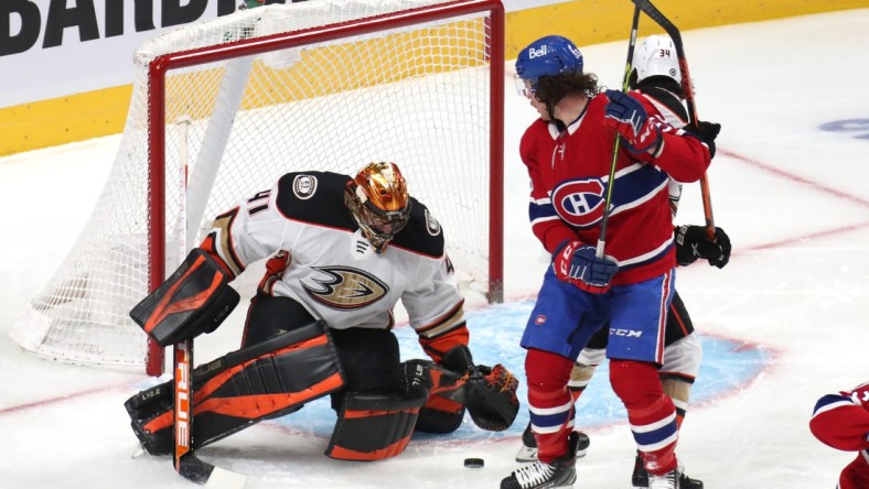 Jan 27, 2022; Montreal, Quebec, CAN; Anaheim Ducks goaltender Anthony Stolarz (41) makes a save against Montreal Canadiens left wing Michael Pezzetta (55) as defenseman Jamie Drysdale (34) defends during the first period at Bell Centre. Mandatory Credit: Jean-Yves Ahern-USA TODAY Sports