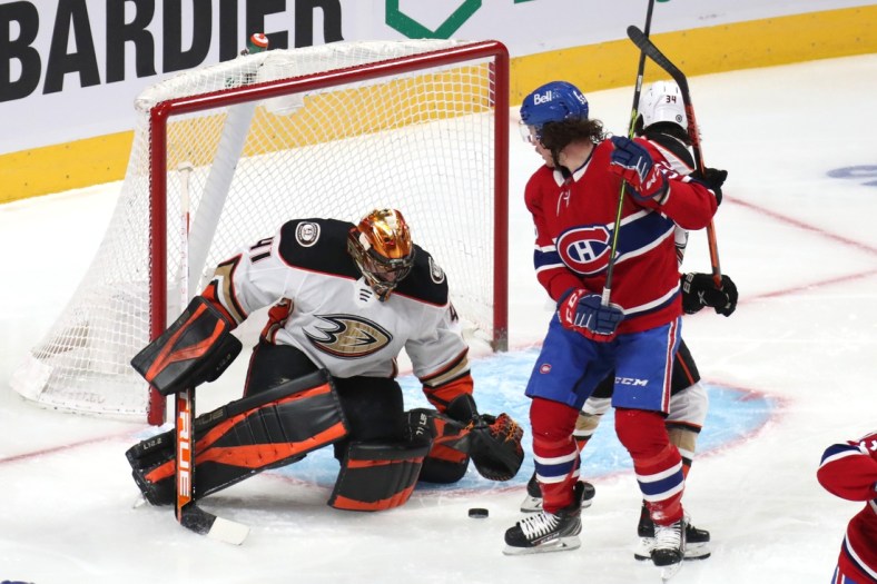 Jan 27, 2022; Montreal, Quebec, CAN; Anaheim Ducks goaltender Anthony Stolarz (41) makes a save against Montreal Canadiens left wing Michael Pezzetta (55) as defenseman Jamie Drysdale (34) defends during the first period at Bell Centre. Mandatory Credit: Jean-Yves Ahern-USA TODAY Sports