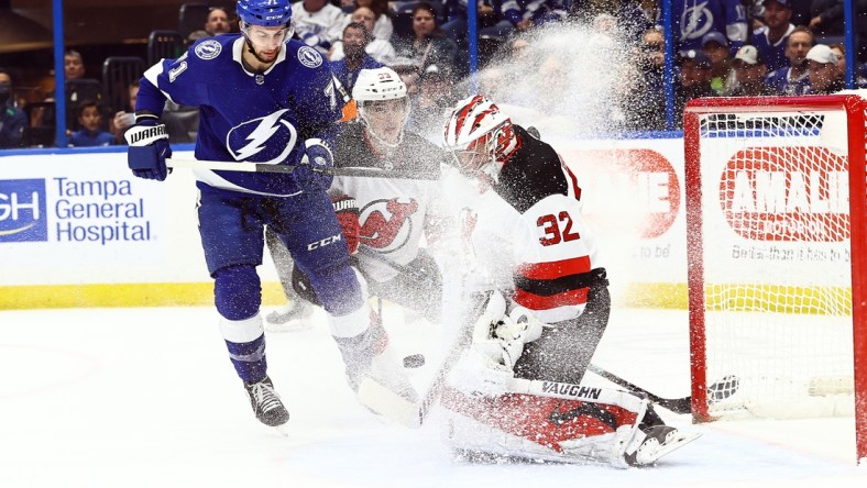 Jan 27, 2022; Tampa, Florida, USA; New Jersey Devils goaltender Jon Gillies (32) makes a save against the Tampa Bay Lightning during the first period at Amalie Arena. Mandatory Credit: Kim Klement-USA TODAY Sports