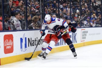Jan 27, 2022; Columbus, Ohio, USA;  New York Rangers defenseman Braden Schneider (45) battles for the puck against Columbus Blue Jackets center Boone Jenner (38) in the second period at Nationwide Arena. Mandatory Credit: Aaron Doster-USA TODAY Sports