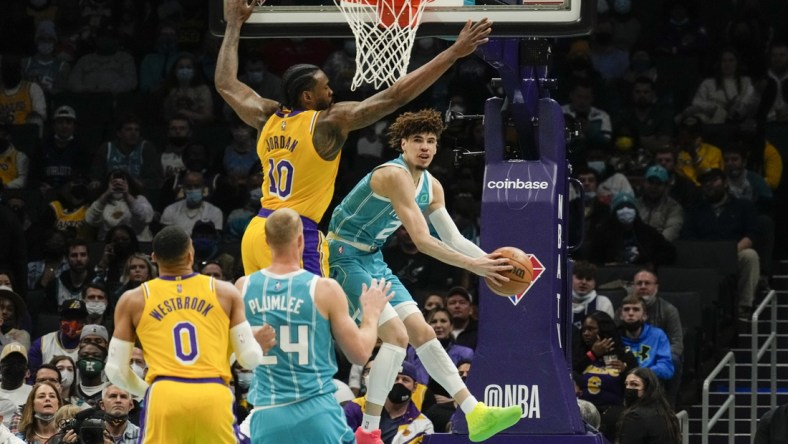 Jan 28, 2022; Charlotte, North Carolina, USA; Charlotte Hornets guard LaMelo Ball (2) gets a pass off around Los Angeles Lakers center DeAndre Jordan (10) to center Mason Plumlee (24) during the first quarter at the Spectrum Center. Mandatory Credit: Jim Dedmon-USA TODAY Sports