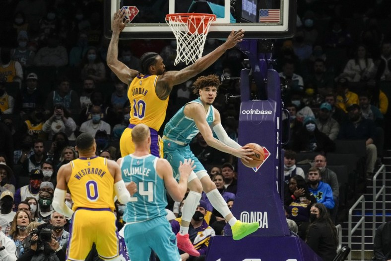 Jan 28, 2022; Charlotte, North Carolina, USA; Charlotte Hornets guard LaMelo Ball (2) gets a pass off around Los Angeles Lakers center DeAndre Jordan (10) to center Mason Plumlee (24) during the first quarter at the Spectrum Center. Mandatory Credit: Jim Dedmon-USA TODAY Sports