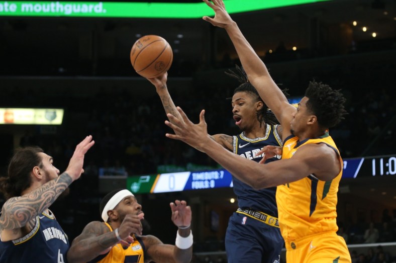 Jan 28, 2022; Memphis, Tennessee, USA; Memphis Grizzles guard Ja Morant (12) passes the ball as Utah Jazz center Hassan Whiteside (21) defends during the first half at FedExForum. Mandatory Credit: Petre Thomas-USA TODAY Sports
