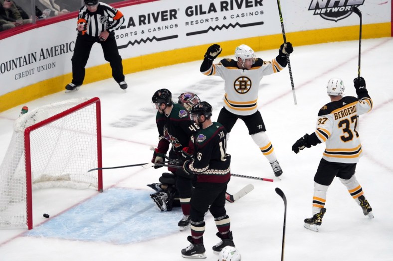 Jan 28, 2022; Glendale, Arizona, USA; Boston Bruins players celebrate a goal by Boston Bruins defenseman Charlie McAvoy (not pictured) during the second period at Gila River Arena. Mandatory Credit: Joe Camporeale-USA TODAY Sports