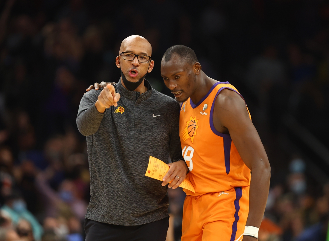 Jan 28, 2022; Phoenix, Arizona, USA; Phoenix Suns head coach Monty Williams (left) with center Bismack Biyombo against the Minnesota Timberwolves in the second half at Footprint Center. Mandatory Credit: Mark J. Rebilas-USA TODAY Sports