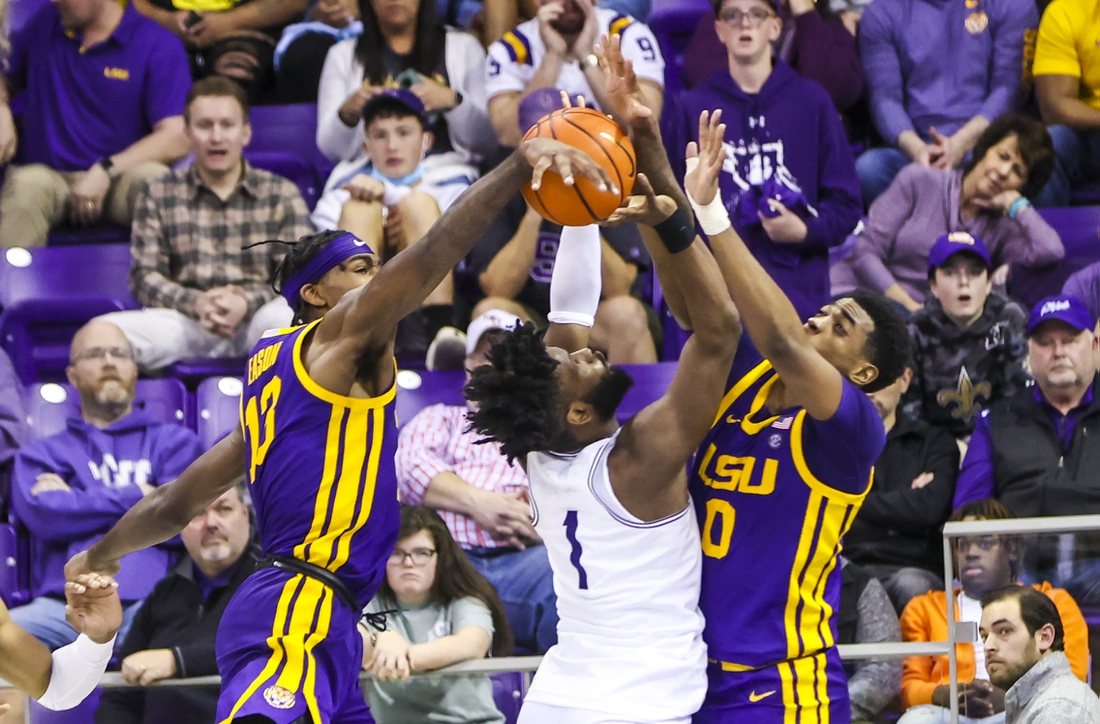 Jan 29, 2022; Fort Worth, Texas, USA;  TCU Horned Frogs guard Mike Miles (1) shoots as LSU Tigers guard Brandon Murray (0) and forward Tari Eason (13) defends during the second half at Ed and Rae Schollmaier Arena. Mandatory Credit: Kevin Jairaj-USA TODAY Sports