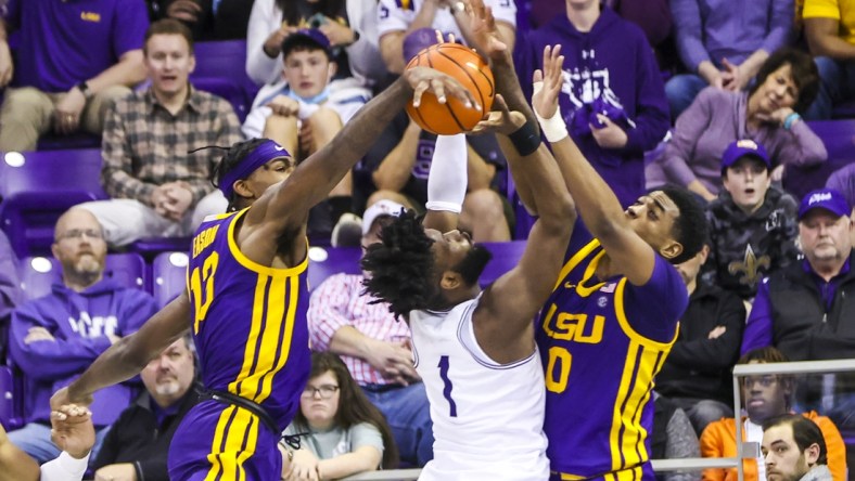 Jan 29, 2022; Fort Worth, Texas, USA;  TCU Horned Frogs guard Mike Miles (1) shoots as LSU Tigers guard Brandon Murray (0) and forward Tari Eason (13) defends during the second half at Ed and Rae Schollmaier Arena. Mandatory Credit: Kevin Jairaj-USA TODAY Sports