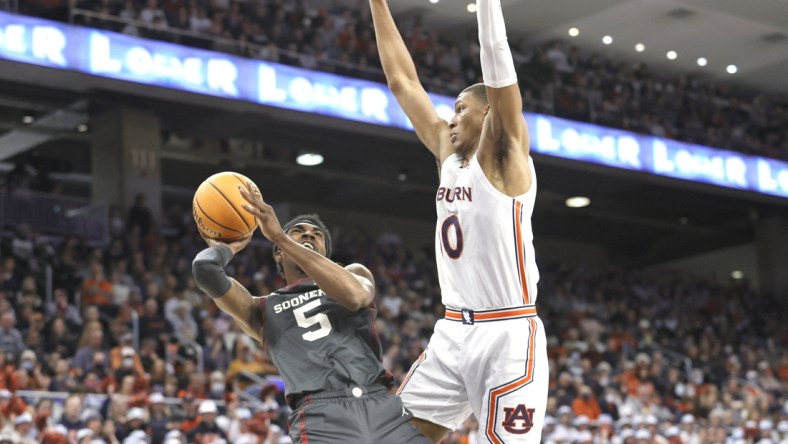 Jan 29, 2022; Auburn, Alabama, USA;  Oklahoma Sooners guard Marvin Johnson (5) takes a shot against Auburn Tigers forward Jabari Smith (10) during the first half at Auburn Arena. Mandatory Credit: John Reed-USA TODAY Sports