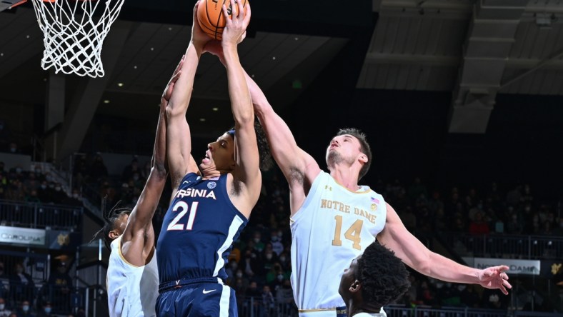 Jan 29, 2022; South Bend, Indiana, USA; Virginia Cavaliers forward Kadin Shedrick (21) and Notre Dame Fighting Irish forward Nate Laszewski (14) reach for a rebound in the first half at the Purcell Pavilion. Mandatory Credit: Matt Cashore-USA TODAY Sports