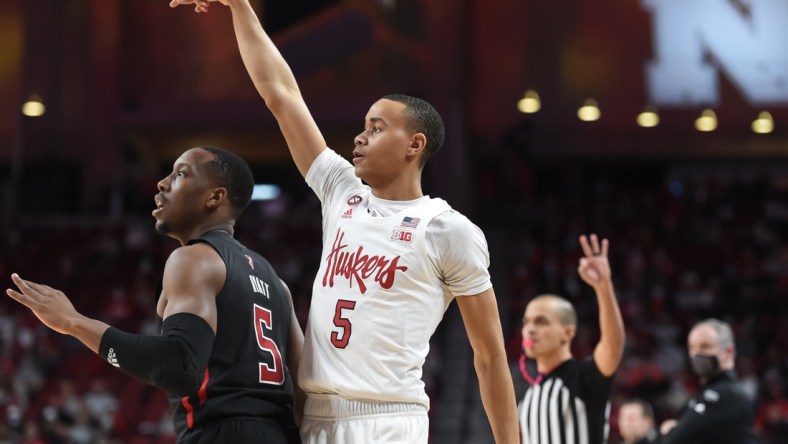 Jan 29, 2022; Lincoln, Nebraska, USA;  Nebraska Cornhuskers guard Bryce McGowens (5) scores on a three point basket against Rutgers Scarlet Knights forward Aundre Hyatt (5) in the first half at Pinnacle Bank Arena. Mandatory Credit: Steven Branscombe-USA TODAY Sports