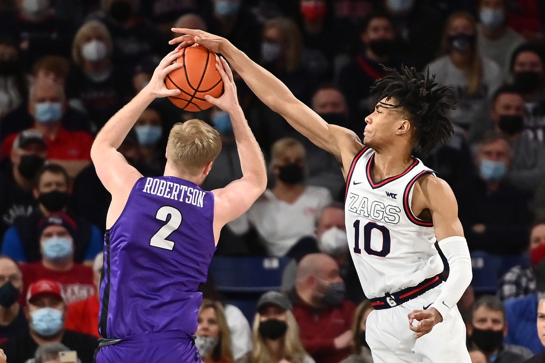 Jan 29, 2022; Spokane, Washington, USA; Portland Pilots guard Tyler Robertson (2) rebounds the ball against Gonzaga Bulldogs guard Hunter Sallis (10) in the first half at McCarthey Athletic Center. Mandatory Credit: James Snook-USA TODAY Sports