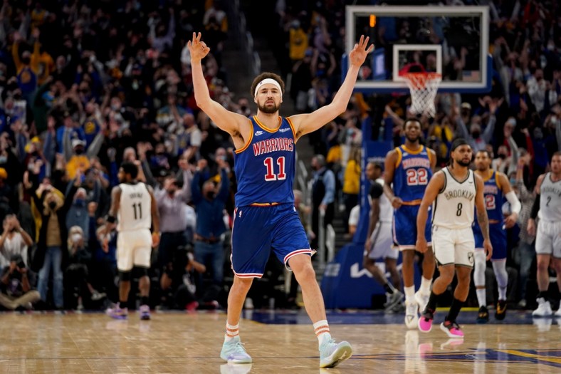 Jan 29, 2022; San Francisco, California, USA; Golden State Warriors guard Klay Thompson (11) celebrates after making a three point basket against the Brooklyn Nets in the fourth quarter at the Chase Center. Mandatory Credit: Cary Edmondson-USA TODAY Sports