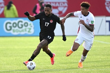 Jan 30, 2022; Hamilton, Ontario, CAN; Canada forward Cyle Larin (17) dribbles the ball away from United States defender Chris Richards (15) during a CONCACAF FIFA World Cup Qualifier soccer match at Tim Hortons Field. Mandatory Credit: Dan Hamilton-USA TODAY Sports