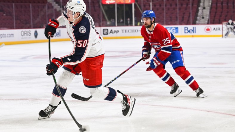 Jan 30, 2022; Montreal, Quebec, CAN; Columbus Blue Jackets left wing Eric Robinson (50) shoots the puck during the first period at Bell Centre. Mandatory Credit: David Kirouac-USA TODAY Sports