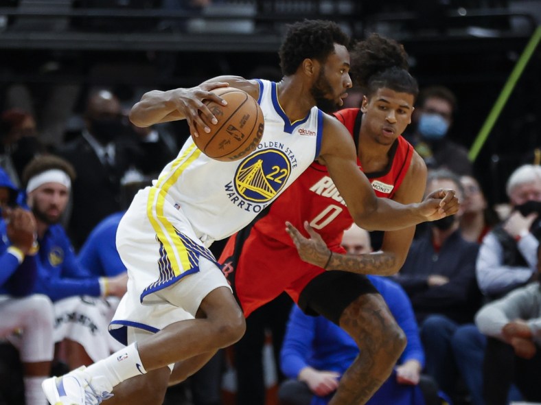 Jan 31, 2022; Houston, Texas, USA; Golden State Warriors forward Andrew Wiggins (22) drives with the ball as Houston Rockets guard Jalen Green (0) defends during the second quarter at Toyota Center. Mandatory Credit: Troy Taormina-USA TODAY Sports