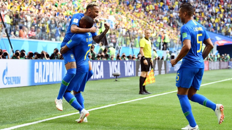 Jun 22, 2018; Saint Petersburg, Russia; Brazil forward Neymar (10), midfielder Casemiro (5) and forward Douglas Costa (7) celebrate after a goal against Costa Rica in Group E play during the FIFA World Cup 2018 at Saint Petersburg Stadium. Mandatory Credit: Tim Groothuis/Witters Sport via USA TODAY Sports