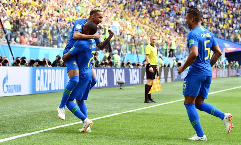 Jun 22, 2018; Saint Petersburg, Russia; Brazil forward Neymar (10), midfielder Casemiro (5) and forward Douglas Costa (7) celebrate after a goal against Costa Rica in Group E play during the FIFA World Cup 2018 at Saint Petersburg Stadium. Mandatory Credit: Tim Groothuis/Witters Sport via USA TODAY Sports