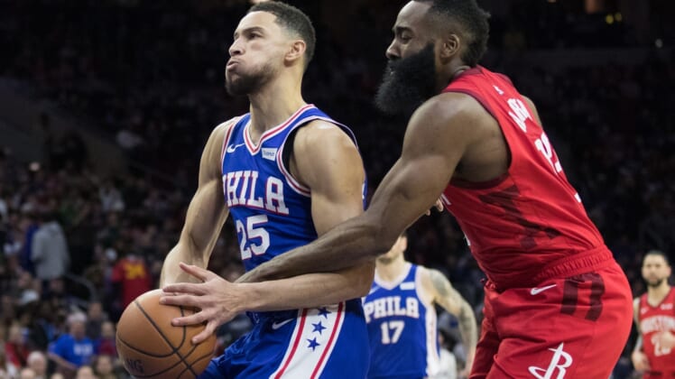 Jan 21, 2019; Philadelphia, PA, USA; Philadelphia 76ers guard Ben Simmons (25) is fouled by Houston Rockets guard James Harden (13) during the third quarter at Wells Fargo Center. Mandatory Credit: Bill Streicher-USA TODAY Sports
