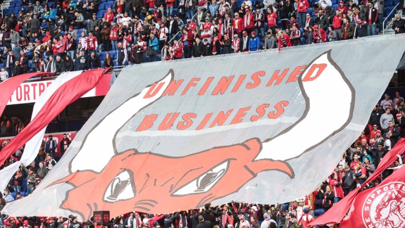 Mar 16, 2019; Harrison, NJ, USA; New York Red Bulls fans unveil a banner that reads "Unfinished Business"  before the game against the San Jose Earthquakes at Red Bull Arena. Mandatory Credit: Vincent Carchietta-USA TODAY Sports