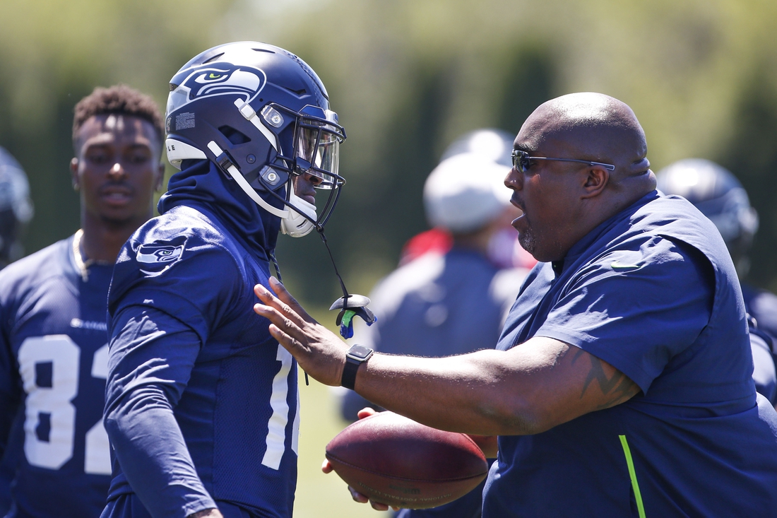 Jun 11, 2019; Renton, WA, USA; Seattle Seahawks defensive line coach Clint Hurtt (right) talks with wide receiver D.K. Metcalf (14) following a drill during minicamp practice at the Virginia Mason Athletic Center. Mandatory Credit: Joe Nicholson-USA TODAY Sports