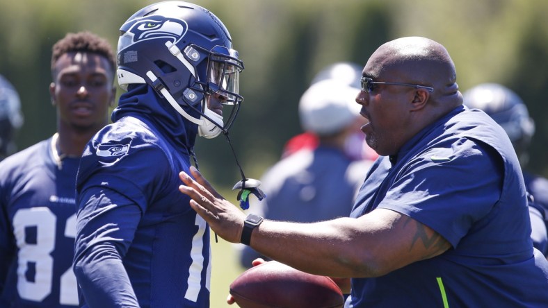 Jun 11, 2019; Renton, WA, USA; Seattle Seahawks defensive line coach Clint Hurtt (right) talks with wide receiver D.K. Metcalf (14) following a drill during minicamp practice at the Virginia Mason Athletic Center. Mandatory Credit: Joe Nicholson-USA TODAY Sports