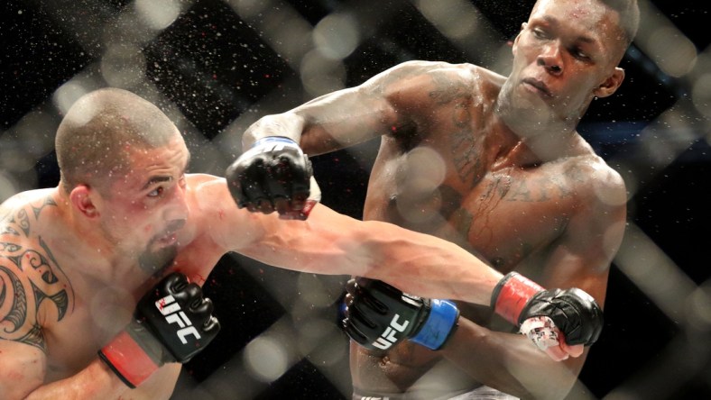 Oct 5, 2019; Melbourne, AUSTRALIA; Israel Adesanya (blue gloves) and Robert Whittaker (red gloves) during UFC 243 at Marvel Stadium. Mandatory Credit: Jasmin Frank-USA TODAY Sports