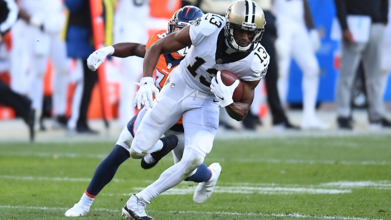 Nov 29, 2020; Denver, Colorado, USA; New Orleans Saints wide receiver Michael Thomas (13) carries the ball against the Denver Broncos in the second quarter at Empower Field at Mile High. Mandatory Credit: Ron Chenoy-USA TODAY Sports