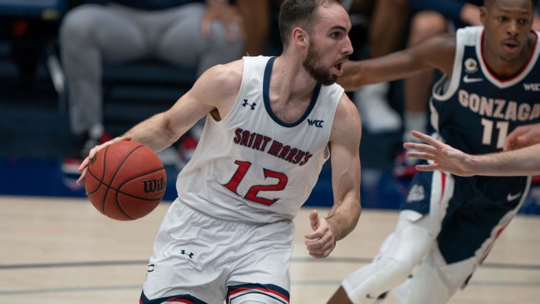 Jan 16, 2021; Moraga, California, USA; St. Mary's Gaels guard Tommy Kuhse (12) drives the ball against the Gonzaga Bulldogs during the first half at McKeon Pavilion. Mandatory Credit: Stan Szeto-USA TODAY Sports