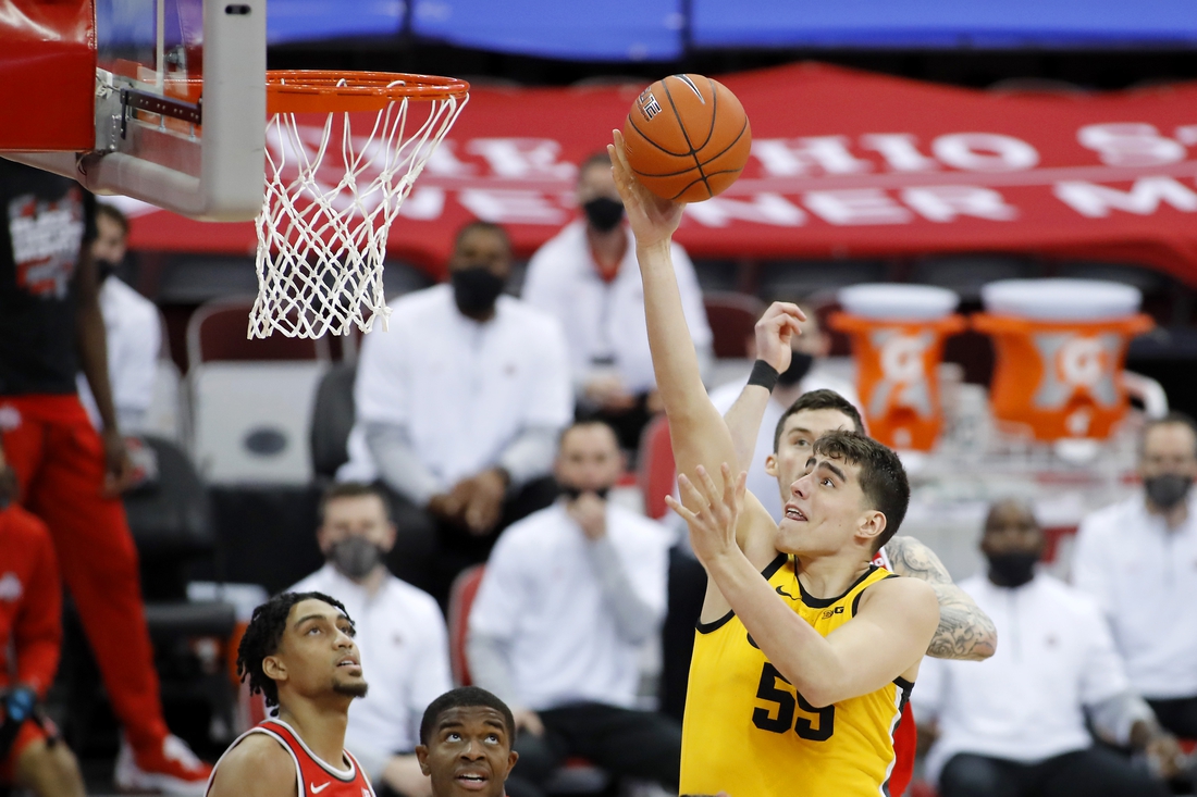 Feb 28, 2021; Columbus, Ohio, USA; Iowa Hawkeyes center Luka Garza (55) goes to the basket as Ohio State Buckeyes guard Duane Washington Jr. (4) defends during the first half at Value City Arena. Mandatory Credit: Joseph Maiorana-USA TODAY Sports