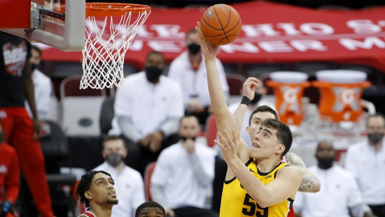 Feb 28, 2021; Columbus, Ohio, USA; Iowa Hawkeyes center Luka Garza (55) goes to the basket as Ohio State Buckeyes guard Duane Washington Jr. (4) defends during the first half at Value City Arena. Mandatory Credit: Joseph Maiorana-USA TODAY Sports