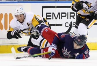 Apr 8, 2021; New York, New York, USA; Pittsburgh Penguins defenseman Brian Dumoulin (8) brings down New York Rangers left wing Chris Kreider (20) during the second period at Madison Square Garden. Mandatory Credit:  Bruce Bennett/Pool Photo-USA TODAY Sports