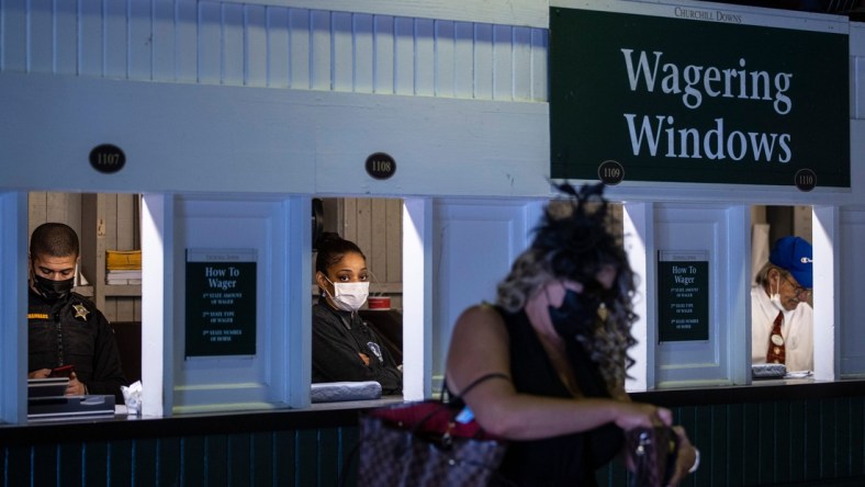 Attendants place bets at the wagering windows on the day of the 147th Kentucky Derby at Churchill Downs. May 1, 2021

As 8368derby Drop3