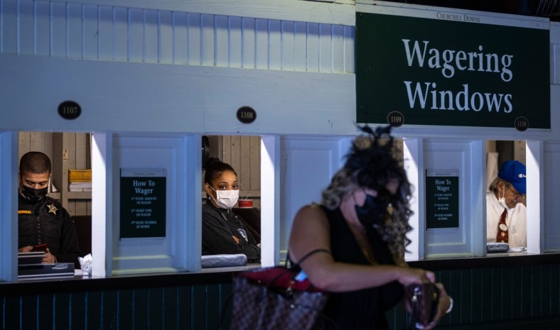 Attendants place bets at the wagering windows on the day of the 147th Kentucky Derby at Churchill Downs. May 1, 2021

As 8368derby Drop3